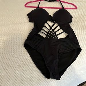 Black Kenneth Cole one-piece bathing suit. Lined cups. Tie neck and back.